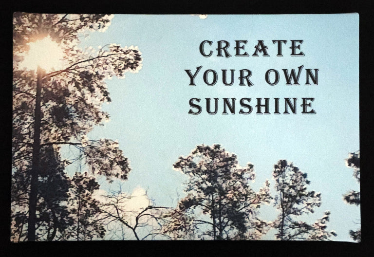 Canvas print with scenic trees and sunlight with 'Create Your Own Sunshine' text.