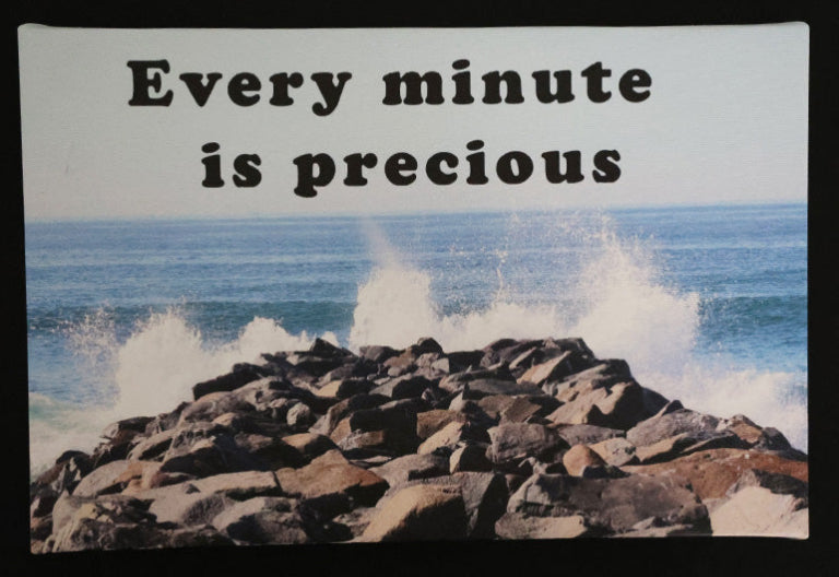 Canvas print with scenic ocean waves crashing against rocks with 'Every minute is precious' text.