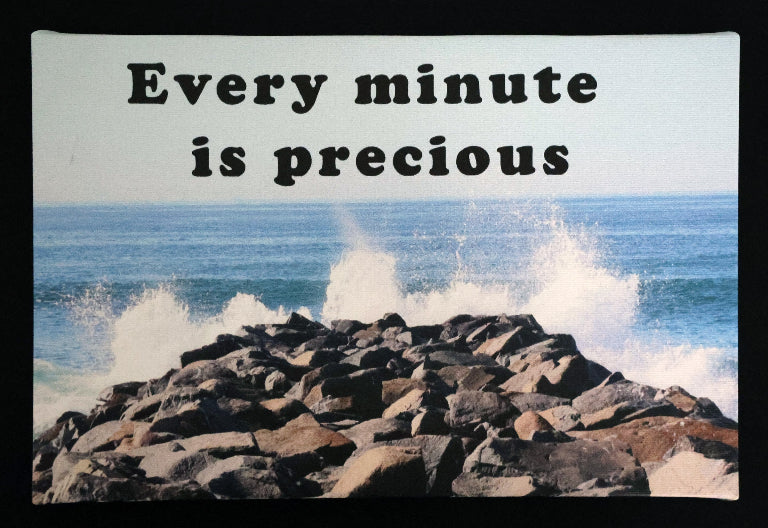 Canvas print with scenic ocean waves crashing against rocks with 'Every minute is precious' text.