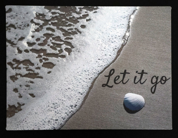 Canvas print with scenic a shell and waves on a beach with 'Let it go' text.