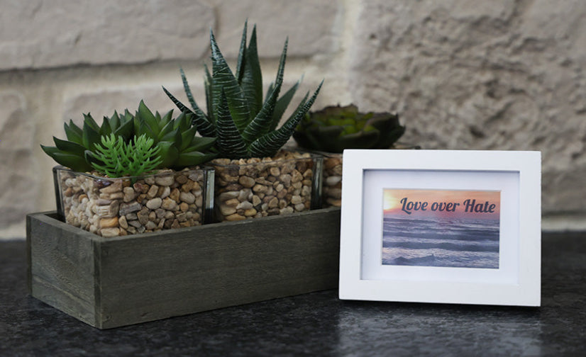 Framed picture with 'Love over Hate' quote.