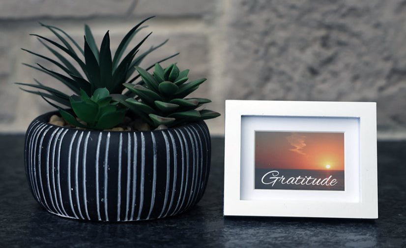 Framed picture with sunset and 'Gratitude' quote.