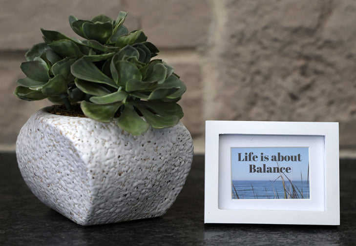 Framed picture with 'Life is about balance' quote.