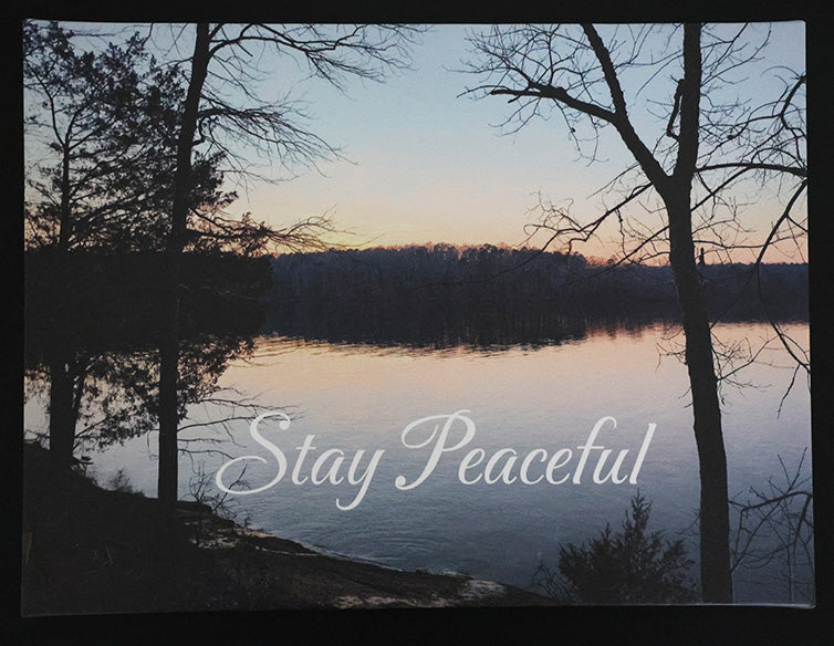 Canvas print with scenic sunset over a lake and trees with 'Stay Peaceful' text.