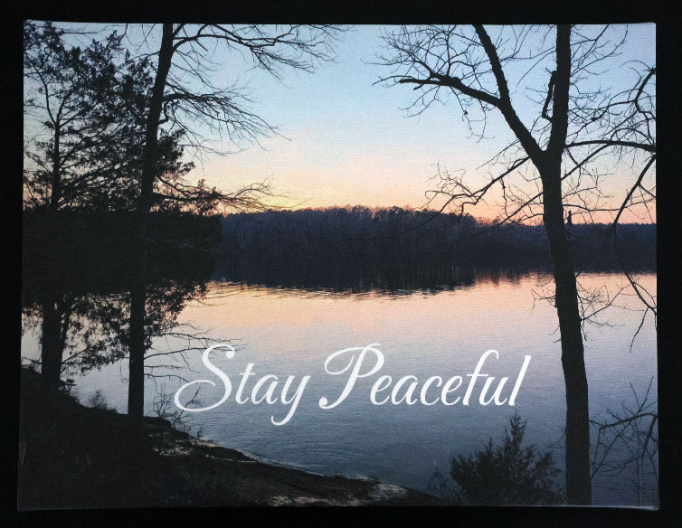 Canvas print with scenic sunset over a lake and trees with 'Stay Peaceful' text.