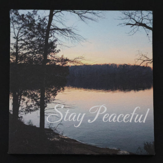 Canvas print with scenic sunset over a lake and trees with 'Stay Peaceful' text.