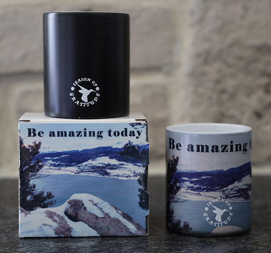 Magic coffee mug with scenic mountain design and 'Be amazing today' quote.