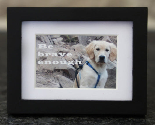 Framed picture with 'Be brave enough' quote.