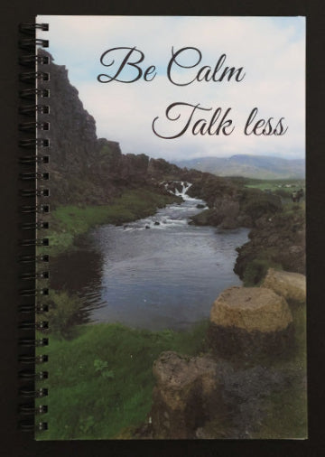 Journal with a scenic cover featuring a river and mountains, with text 'Be Calm Talk Less'.