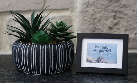 Framed picture with 'Be gentle with yourself' quote.