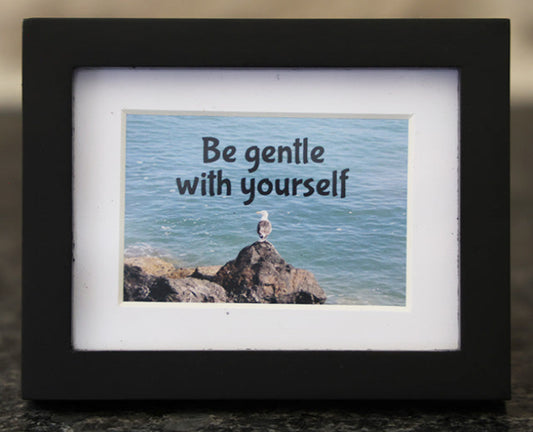 Framed picture with 'Be gentle with yourself' quote.