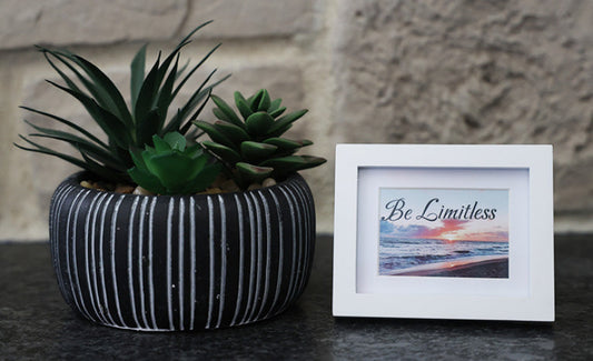 Framed picture with 'Be Limitless' quote.