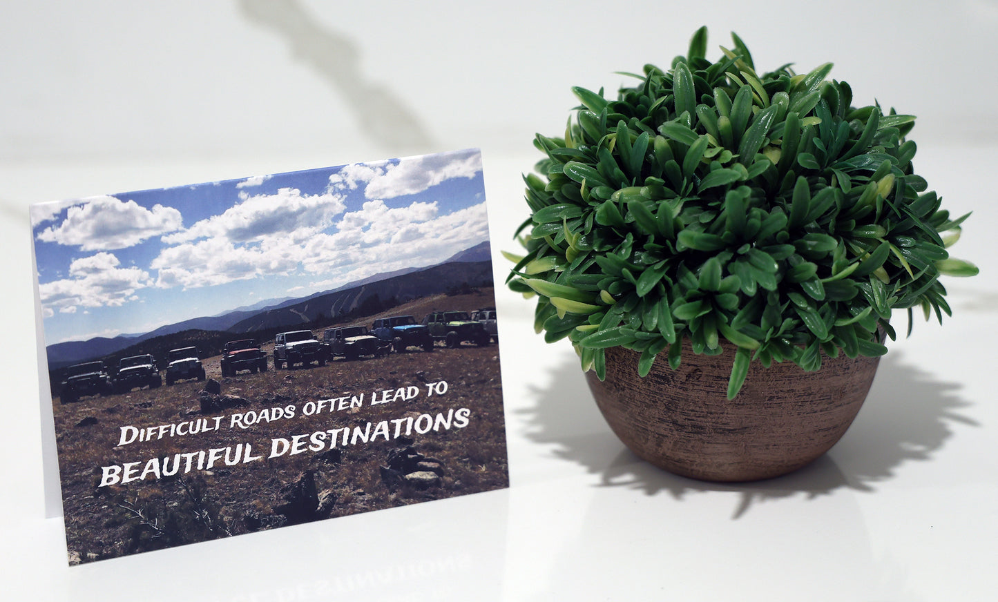 Note card with line of jeeps in scenic mountains and "Beautiful Destinations" quote.