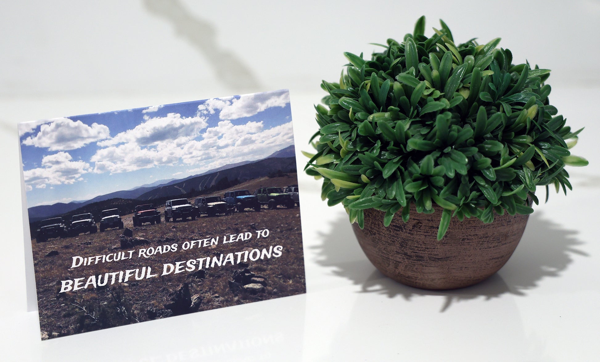 Note card with line of jeeps in scenic mountains and "Beautiful Destinations" quote.