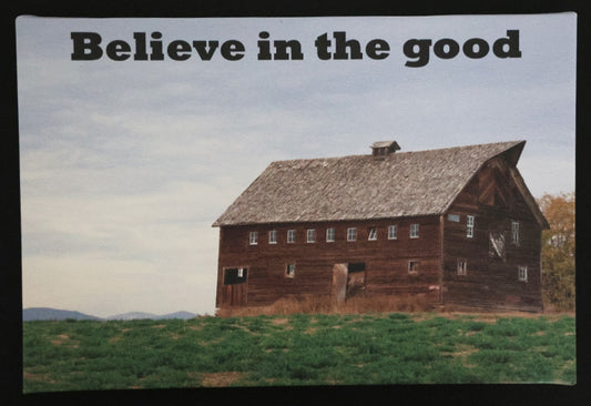 Canvas print with scenic wooden barn in a field with 'Believe in the good' text.