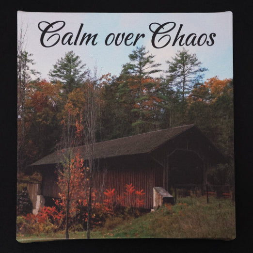 Canvas print with scenic view of a covered bridge in the fall, with 'Calm over Chaos' text.