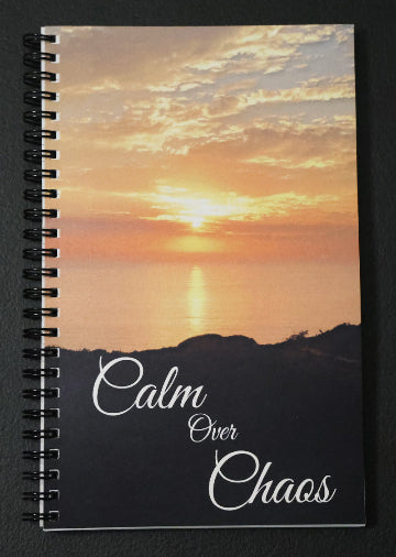 Journal with a scenic beach sunset cover, featuring the text "Calm over Chaos".