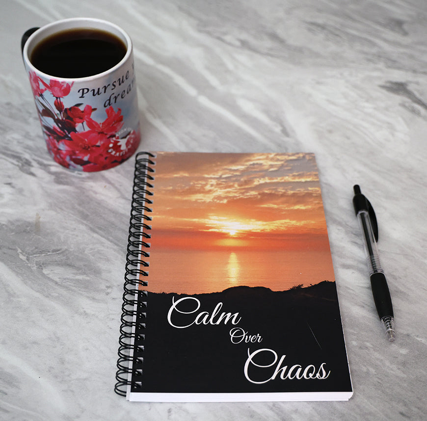 Journal with a scenic beach sunset cover, featuring the text "Calm over Chaos".