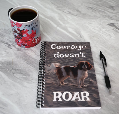Journal with a dog on the beach on the cover with text 'Courage doesn't roar'.