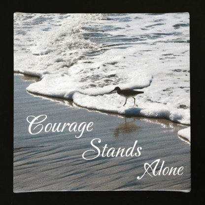 Canvas print with scenic view of bird walking on the beach with 'Courage Stands Alone' text.