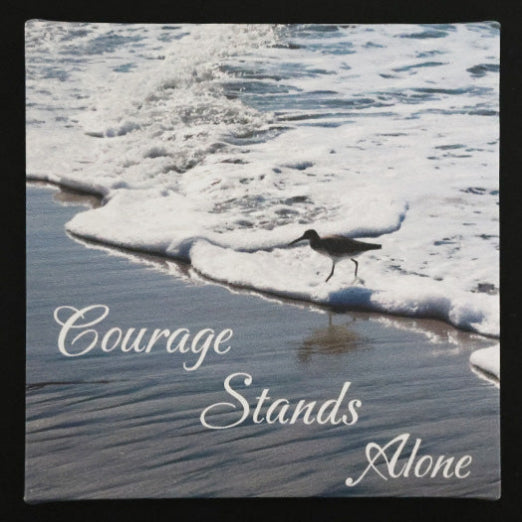 Canvas print with scenic view of bird walking on the beach with 'Courage Stands Alone' text.
