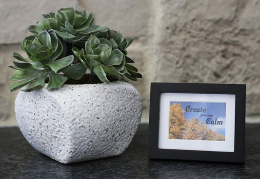Framed picture with 'Create your own Calm' quote.