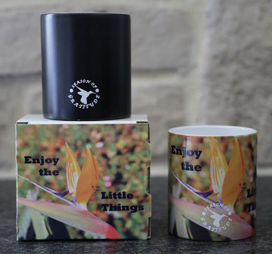 Magic coffee mug with scenic flower design and 'Enjoy the Little Things' quote.