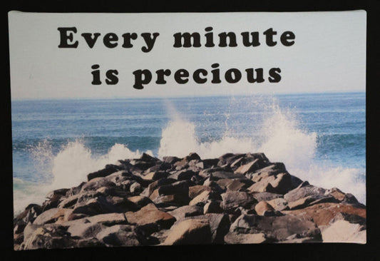 Canvas print with scenic ocean waves crashing against rocks with 'Every minute is precious' text.