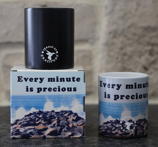 Magic coffee mug with scenic beach design and 'Every minute is precious' quote.