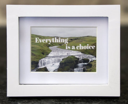 Framed picture with 'Everything is a choice' quote.