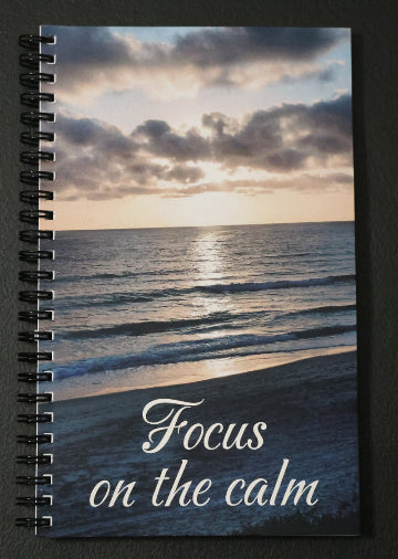 Journal with a beach sunset scene on the comer and 'Focus on the calm' text.