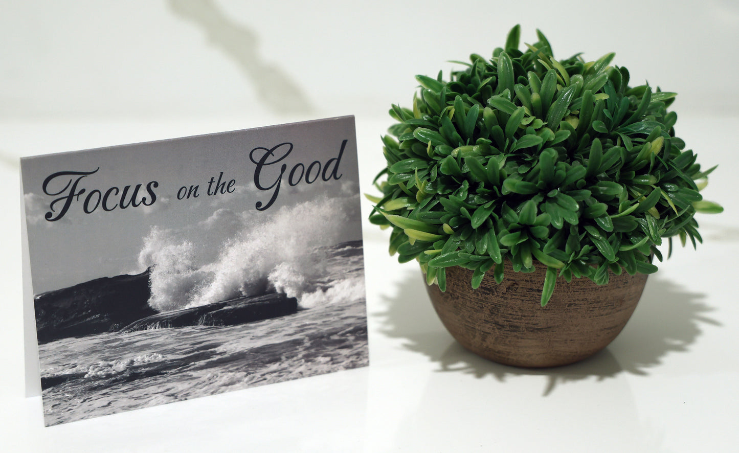Note card with scenic beach and "Focus on the good" quote.