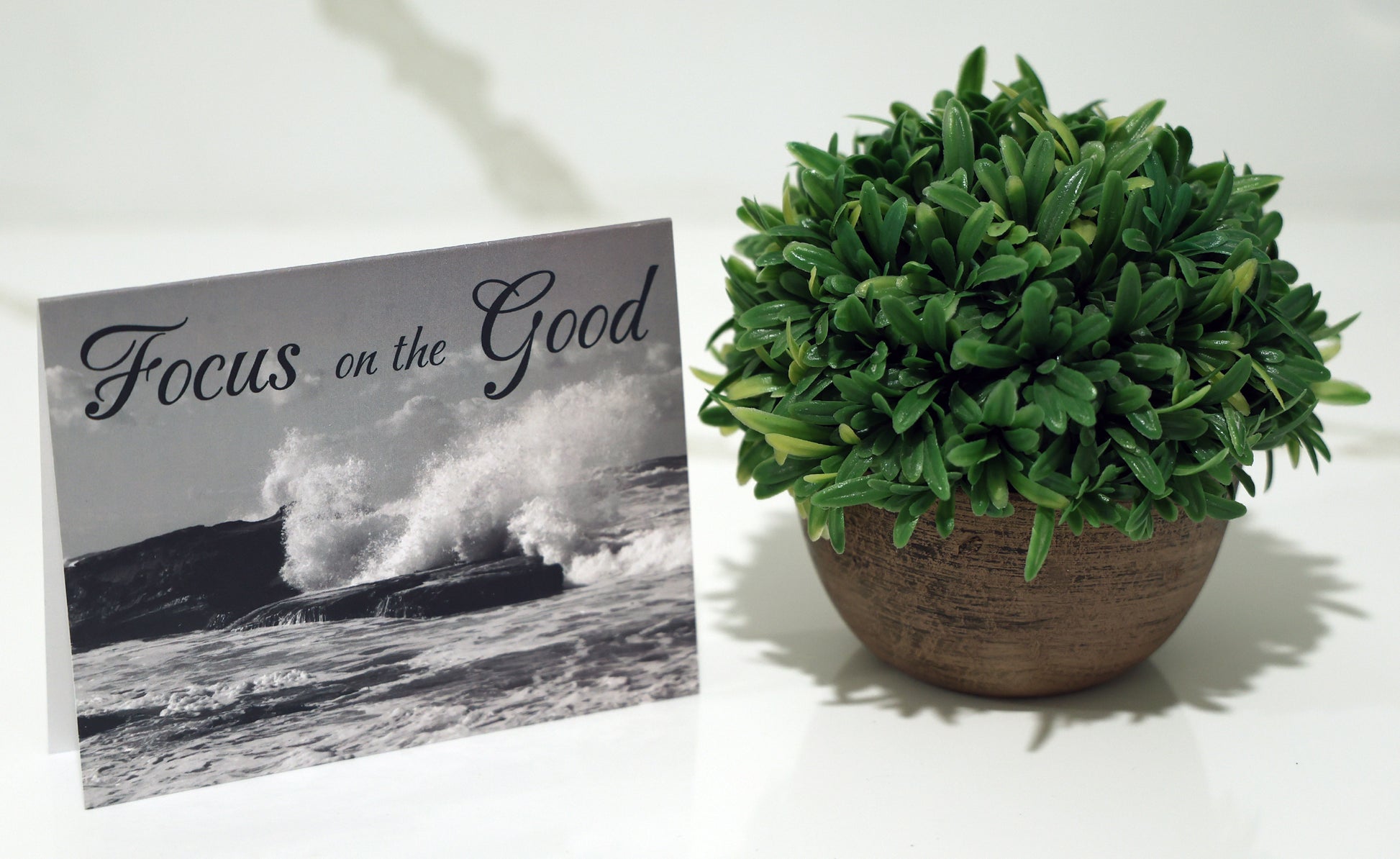 Note card with scenic beach and "Focus on the good" quote.