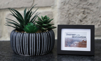 Framed picture with 'Journey is the destination' quote.