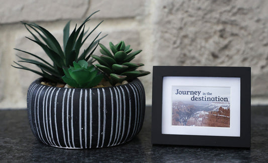 Framed picture with 'Journey is the destination' quote.