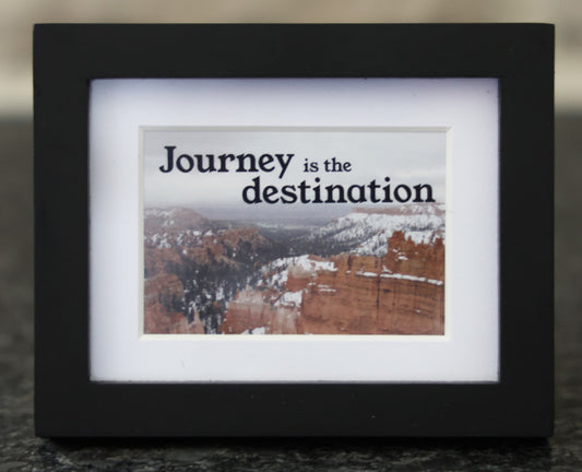 Framed picture with 'Journey is the destination' quote.
