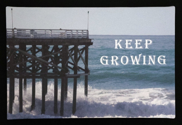 Canvas print with scenic pier extending into the ocean with 'KEEP GROWING' text.