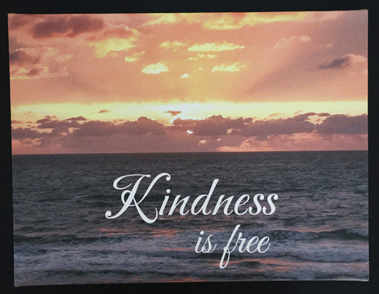 Canvas print with scenic sunset over the ocean with 'Kindness is free' text.