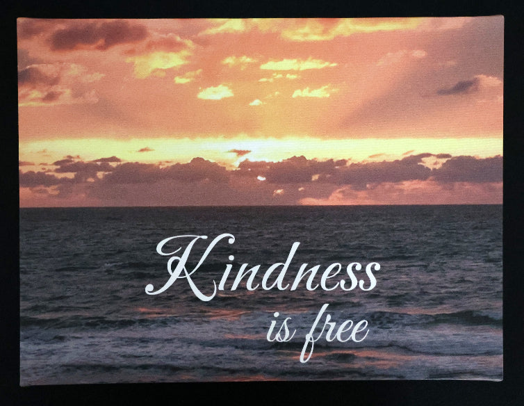 Canvas print with scenic sunset over the ocean with 'Kindness is free' text.