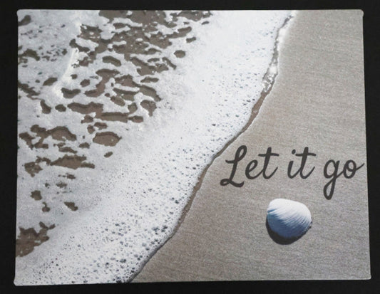Canvas print with scenic a shell and waves on a beach with 'Let it go' text.