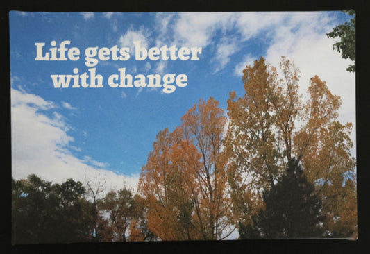 Canvas print with scenic autumn leaves and blue sky with 'Life gets better with change' text.