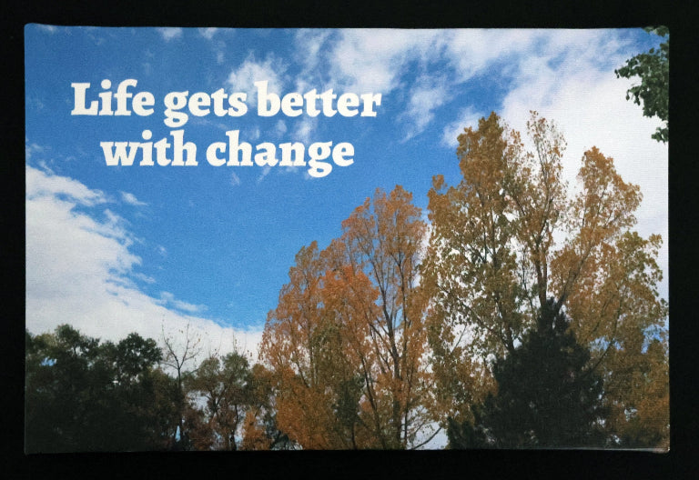 Canvas print with scenic autumn leaves and blue sky with 'Life gets better with change' text.