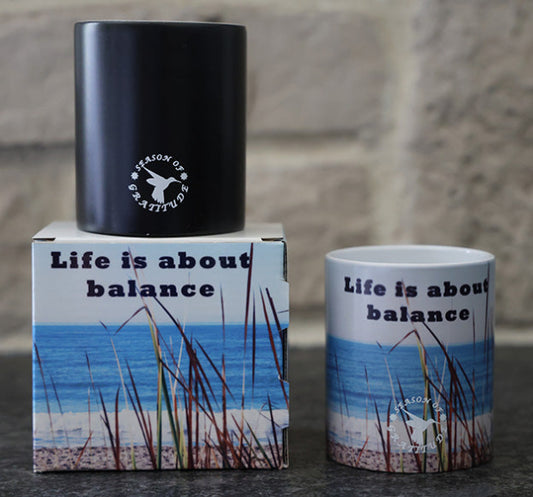 Magic coffee mug with scenic beach design and 'Life is about balance' quote.
