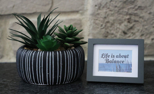 Framed picture with 'Life is about balance' quote.