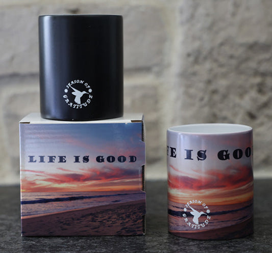 Magic coffee mug with scenic beach sunset design and 'Life is good' quote.