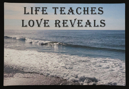 Canvas print with scenic ocean waves with 'LIFE TEACHES LOVE REVEALS' text.