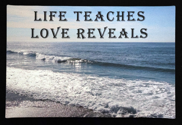 Canvas print with scenic ocean waves with 'LIFE TEACHES LOVE REVEALS' text.