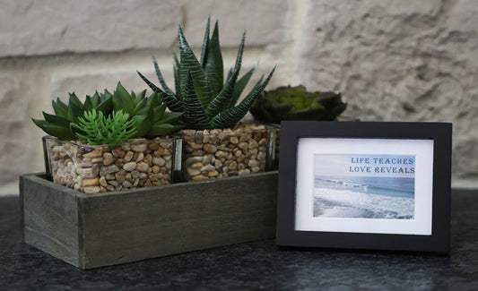Framed picture with 'Life Teaches Love Reveals' quote.