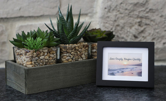 Framed picture with 'Love Deeply, Forgive Quickly' quote.