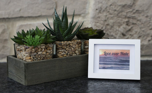 Framed picture with 'Love over Hate' quote.
